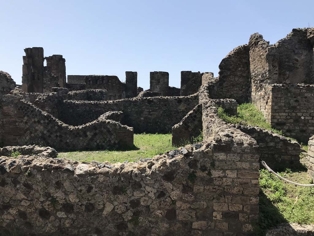 VI.6.5 Pompeii, on left. April 2019. 
Looking west from Vicolo della Fullonica, across rear oven room of bakery at VI.6.4/5, towards doorway to another rear room. Photo courtesy of Rick Bauer.

