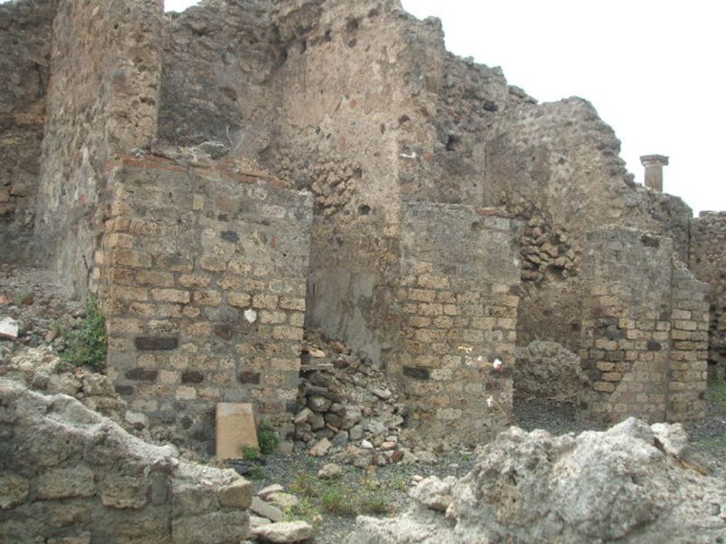 VI.6.7 from VI.6.6 Pompeii. May 2005. Doorways to rooms on west side of atrium, kitchen, cubiculum and tablinum or another cubiculum. In the night of 14th-15th September 1943, a bomb fell near here destroying three rooms with four dividing walls and the perimeter wall, part of VI.6.6/7.
See Garcia y Garcia, L., 2006. Danni di guerra a Pompei. Rome: LErma di Bretschneider. (p.76)
