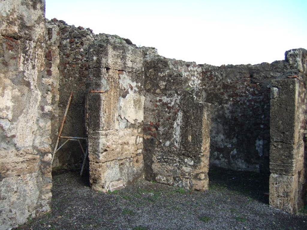 VI.6.9 Pompeii. December 2005. Doorways to rooms in north-east corner of atrium. On the right would be a doorway into the cubiculum from the north side of the entrance corridor. On the left would be the doorway leading into the kitchen, and a storeroom.
