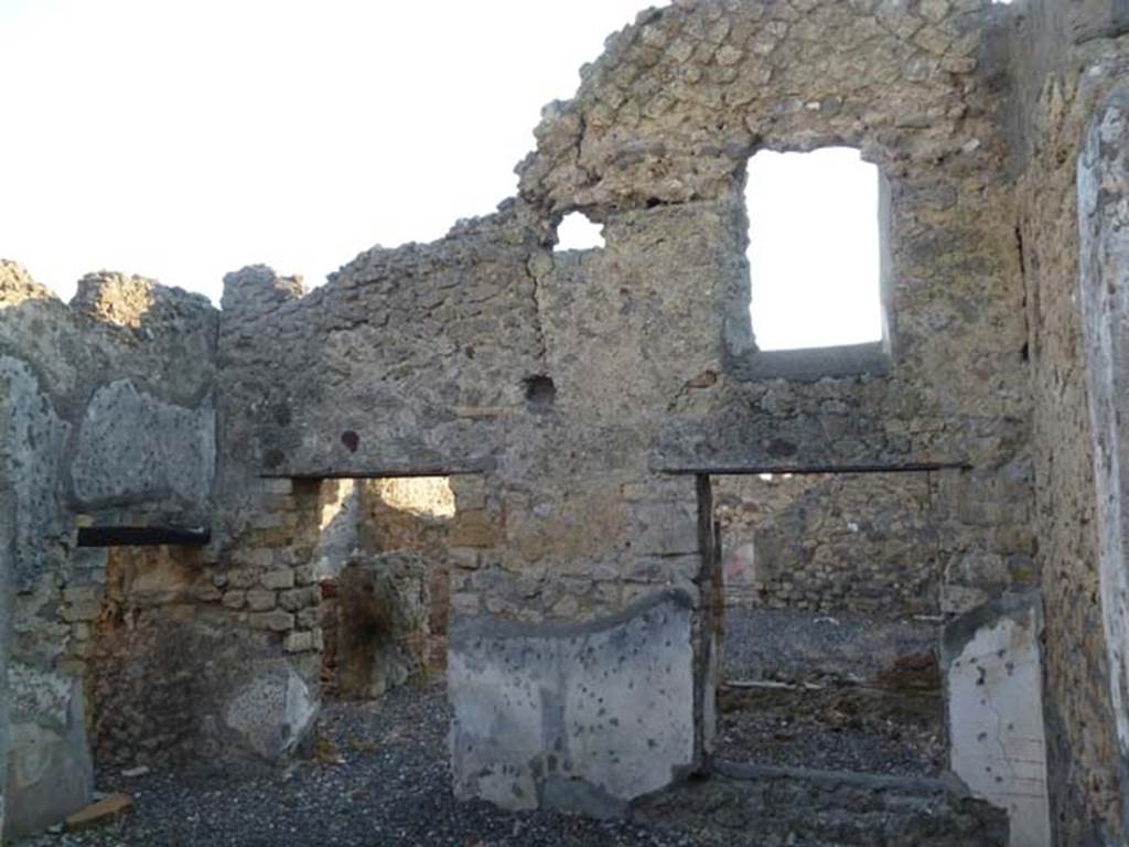 VI.7.1 Pompeii. May 2011. Looking west from triclinium at rear of light-well, into open tablinum (centre) and light-well (right). On the left is the doorway to the small room or storeroom, in the south wall.
