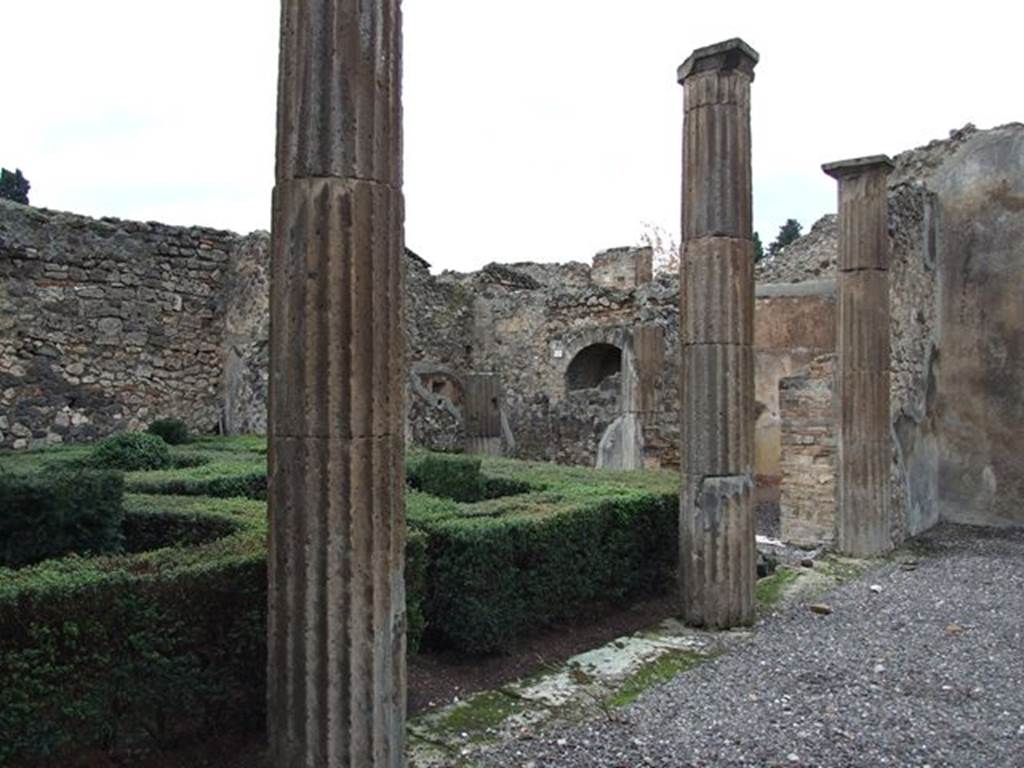 VI.7.19 Pompeii. December 2006. Looking north-west across east portico towards kitchen area, and exedra on north side of portico.
