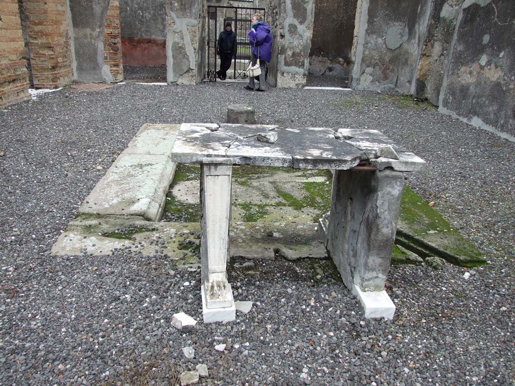 VI.7.19 Pompeii. December 2006.  
Looking east from rear of table, across atrium to entrance doorway and doorway to bedroom on either side.
