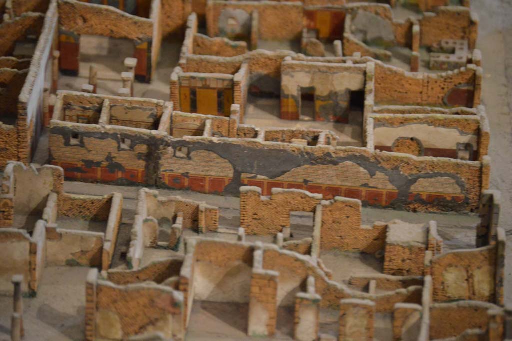 VI.8.3 Pompeii, entrance doorway, on left side of centre, in Vicolo della Fullonica. Detail from model in Naples Archaeological Museum.
Looking towards detail of east wall of roadway, exterior wall of VI.8.3/5, the House of the Tragic Poet. 
Foto Taylor Lauritsen, ERC Grant 681269 DÉCOR.
(For other photos of the detail of the exterior wall, see Vicolo della Fullonica).


