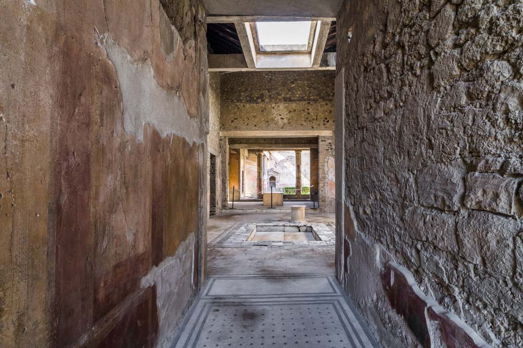 VI.8.3/5 Pompeii. April 2022. 
Looking north along entrance corridor across atrium towards peristyle with lararium. Photo courtesy of Johannes Eber.
