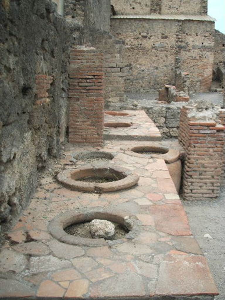 VI.8.8 Pompeii. May 2005. Counter with five Dolia on west side.