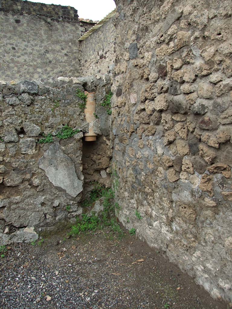 VI.8.9 Pompeii. May 2010. Downpipe in north-west corner of rear room.