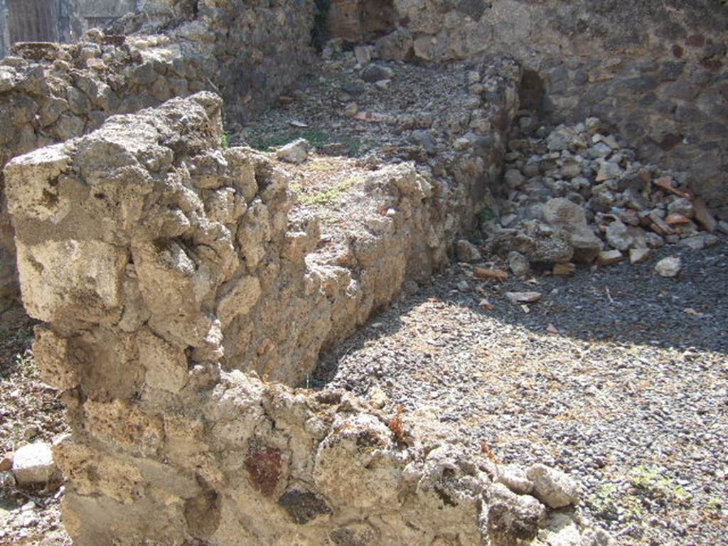 VI.9.12 Pompeii. September 2005. Room 36, south-east corner and south wall of storeroom at rear of kitchen. On the left can be seen the site of the stairs to the upper floor.

