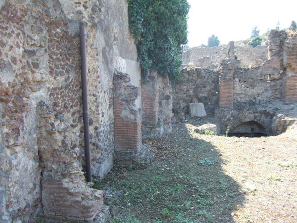 VI.9.13 Pompeii. September 2005. Room 44, south wall and south-west corner. Looking west. A corridor (30) ran from the south-east corner of room 44 joining it to VI.9.2. This is now blocked.
