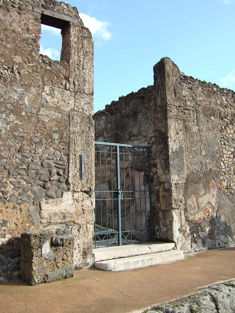 VI.10.7 Pompeii. December 2005. Entrance doorway.  
According to Pagano and Prisciandaro, found in August 1826, painted in red, on the external wall between VI.10.7 & 8 (on the right) was

N(umerium) Barcham IIV(irum) v(irum) b(onum) o(ro) v(os) f(aciatis) ita v(obeis) Venus Pomp(eiana) sacra (sancta propitia sit)      [CIL IV 26]

Many other graffiti were also found on the same wall, see doorway at VI.10.8 for these.

In January 1827 found on the left of the doorway, between VI.10.6 and 7, were –
M(arcum) Holconium
C(aium) Gavium IIvir(os)
/[       [CIL IV 155]

M(arcum) Cerrinium
Vatiam aed(ilem)
Tintirius rog(at)      [CIL IV 156]

Holconium
Priscum IIvir(um)      [CIL IV 157]

Found on the front external wall, was –
M(arcum) Valerium aed(ilem)   
/[       [CIL IV 154

See Pagano, M. and Prisciandaro, R., 2006. Studio sulle provenienze degli oggetti rinvenuti negli scavi borbonici del regno di Napoli. Naples: Nicola Longobardi. (p.136)   

