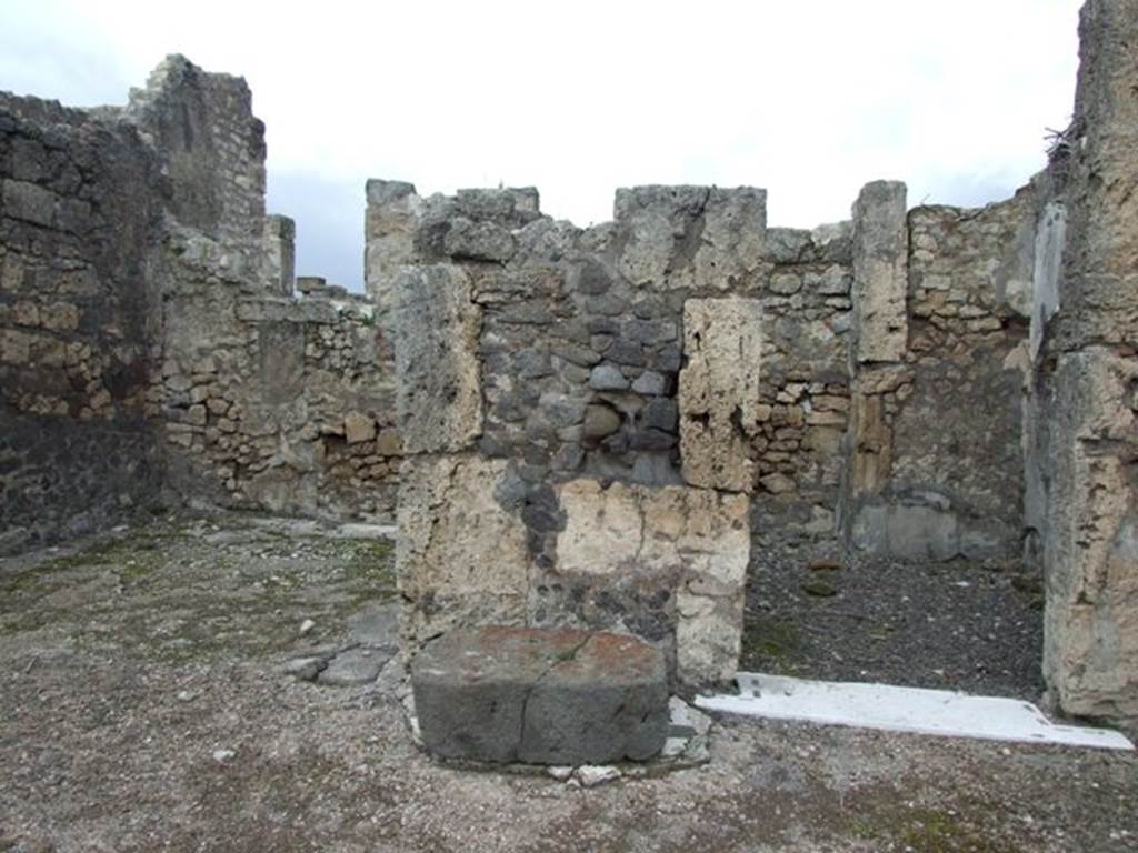 VI.10.7 Pompeii. March 2009. Room 1, north side of atrium.  Large lava stone base for arca or cash-chest covering black and white mosaic floor remains, from between doorways to rooms 5 and 6.
