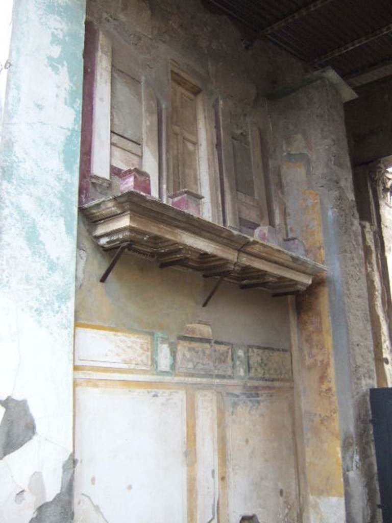 VI.12.2 Pompeii. December 2005. Entrance fauces. East wall with shelf, on which is placed a façade with small columns.
