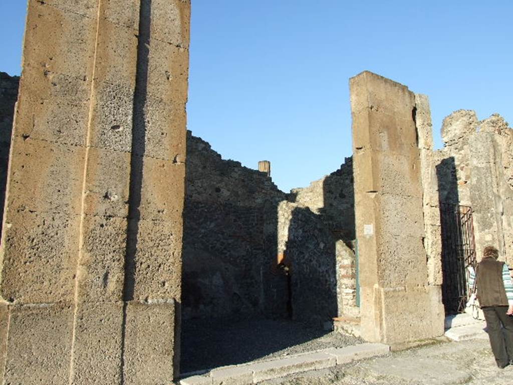 VI.12.4 Pompeii. December 2006. Entrance doorway, with the possible site of graffito below, on right between VI.12.4 and 5. According to Pagano and Prisciandaro, graffito found, painted in red, on the 3rd pilaster after entrance 2 was 
M(arcum) Holconium Priscum
C(aium) Gavium Rufum IIvir(os)
[3]ellus fecit Saturninus.    [CIL IV 297 and CIL IV 297a]
See Pagano, M. and  Prisciandaro, R., 2006. Studio sulle provenienze degli oggetti rinvenuti negli scavi borbonici del regno di Napoli.  Naples : Nicola Longobardi. (p.145)  PAH III, 116.
