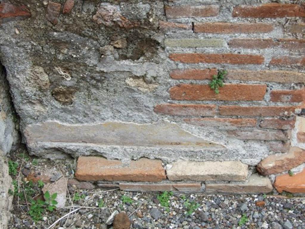 VI.13.2 Pompeii. March 2009. Base of altar, remains of painted plaster on west side.