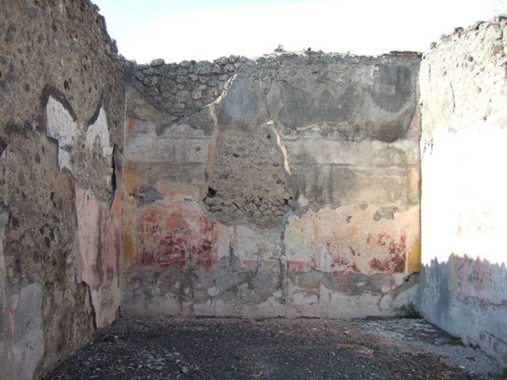 VI.13.2 Pompeii. September 2005. Summer triclinium, looking north. According to Bragantini, upon excavation the north wall was seen with a red plinth and a black zoccolo. The middle zone had a central aedicula panel with a blue background, with painted medallion of a sacred landscape. The side panels were red, separated by narrow black compartments. At the corners, were narrow yellow panels with a design of silver painted candelabra. The frieze had still-lifes of fruit, vases, etc, and the upper zone of the wall was red. The east wall, on the right, was similar to the west wall, with a red plinth and black zoccolo. A central aedicula with blue background had a red predella and a painted sacred landscape. The red side panels were separated by narrow yellow compartments with painted silver candelabra design.
See Bragantini, de Vos, Badoni, 1983. Pitture e Pavimenti di Pompei, Parte 2. Rome: ICCD. (p.263, triclinio ‘20’).


