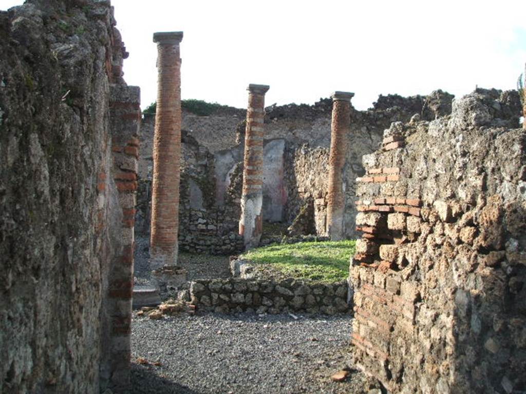 VI.13.9 Pompeii. December 2004. Looking west across peristyle, from rear entrance. According to Garcia y Garcia, in 1943 a bomb destroyed the rear entrance at VI.13.9. The three nearby rooms on the south-east side of the peristyle were destroyed as well as a good part of the east wall. See Garcia y Garcia, L., 2006. Danni di guerra a Pompei. Rome: LErma di Bretschneider. (p.86-87)
According to Jashemski, numerous graffiti found indicated that the peristyle had been converted into a spinning and weaving establishment. See VI.13.8 for the graffiti. This area was badly damaged by the 1943 bombing.
See Jashemski, W. F., 1993. The Gardens of Pompeii, Volume II: Appendices. New York: Caratzas. (p.147)
