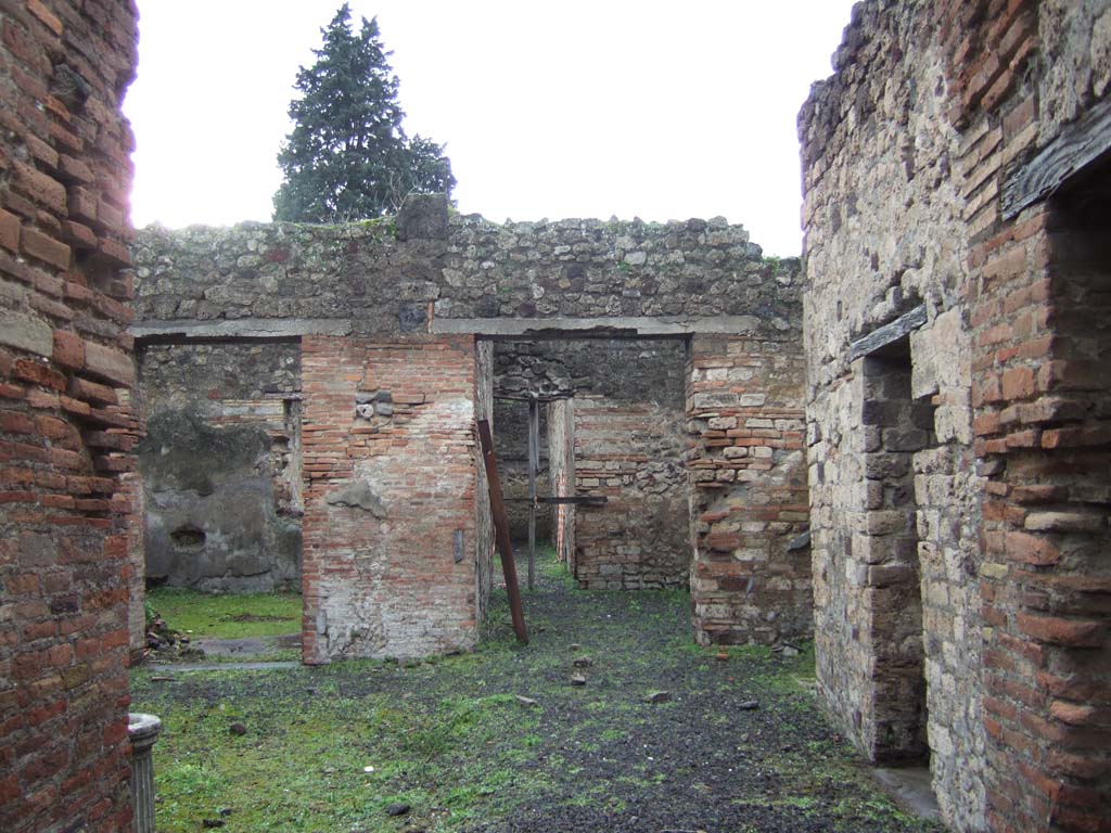 VI.13.16 Pompeii. December 2005. Two doorways on west side of atrium.
On the left is the doorway to the large room with a window, in the centre is the doorway to the room communicating with the garden area.
