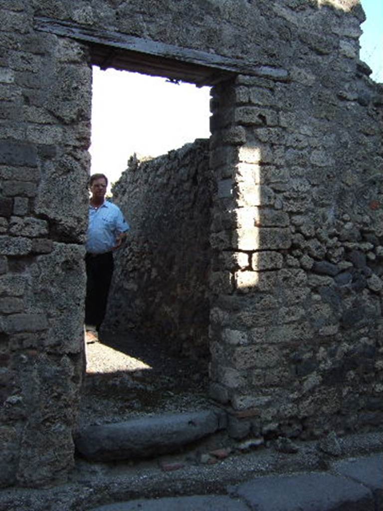 VI.13.20 Pompeii. September 2005. Entrance doorway, looking east. This exterior doorway originally only led into a room with stairs leading directly to the rooms on the upper floor.
