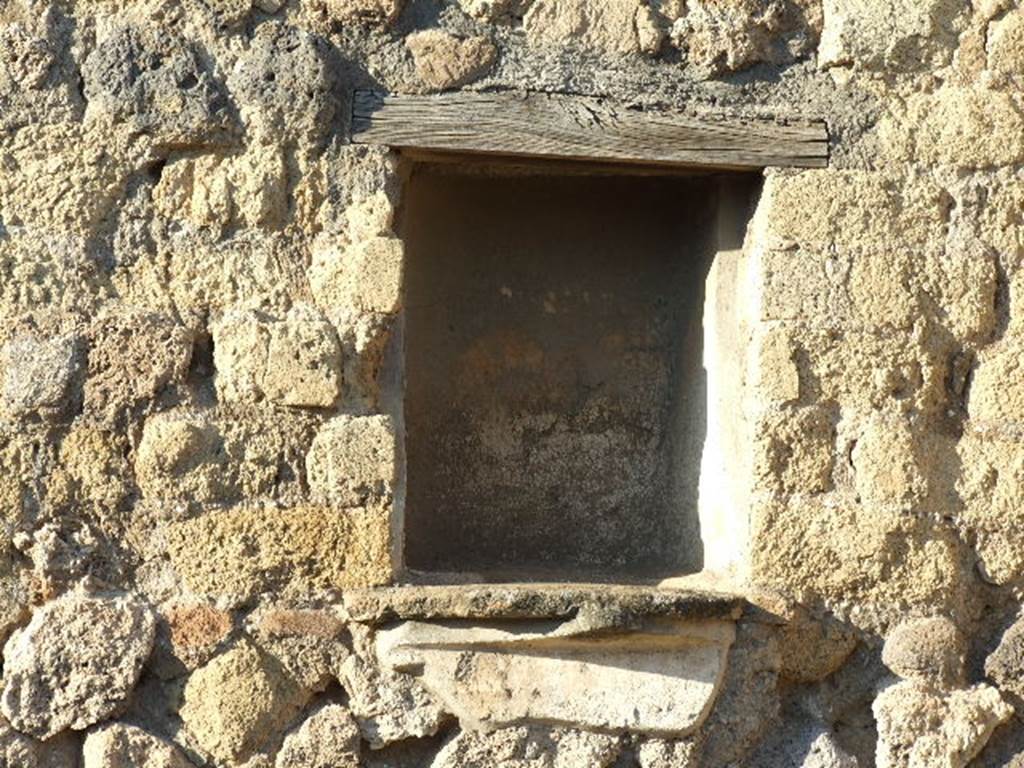 VI.14.4 Pompeii. December 2006. Niche in north wall of shop.
According to Boyce, in the north wall is a rectangular niche, its inside walls coated with white stucco.
Its floor projected as a narrow shelf.
See Boyce G. K., 1937. Corpus of the Lararia of Pompeii. Rome: MAAR 14. (p. 52, no.196) 
