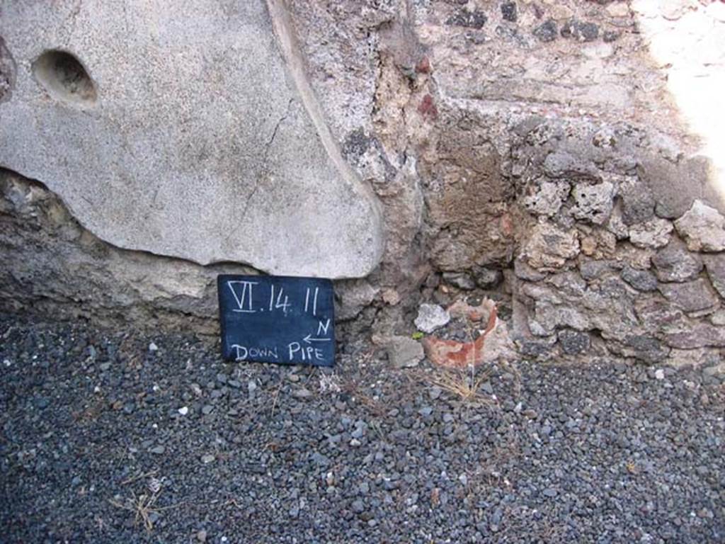 VI.14.11 Pompeii. July 2008. Downpipe in east wall of shop. Photo courtesy of Barry Hobson.