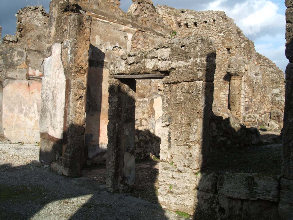 VI.14.12 Pompeii. December 2004. Two doorways to cubicula on east side of atrium.