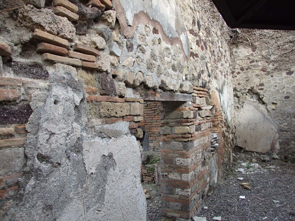 VI.14.34 Pompeii. December 2007. 
Garden-yard in south-east corner. Looking north through doorway from garden-yard towards oven in bakery.
