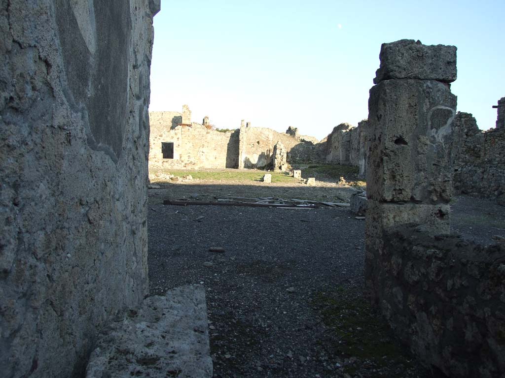 VI.14.38 Pompeii. December 2007. Looking east across atrium, tablinum and peristyle, from entrance doorway.
According to Garcia y Garcia, this house was badly hit by the 1943 bombing.
It caused the destruction of the atrium floor, including the impluvium and the marble table.
Also destroyed were the two rooms nearby on the north side of the atrium with their decoration, the south wall of the peristyle and the loss of the IV Style painted plaster in two rooms adjacent to the north-east of this.
The stucco of four of the columns in the peristyle also collapsed.
Today the house still appears a complete ruin. 
See Garcia y Garcia, L., 2006. Danni di guerra a Pompei. Rome: L’Erma di Bretschneider. (p.91-93, incl. photos).
