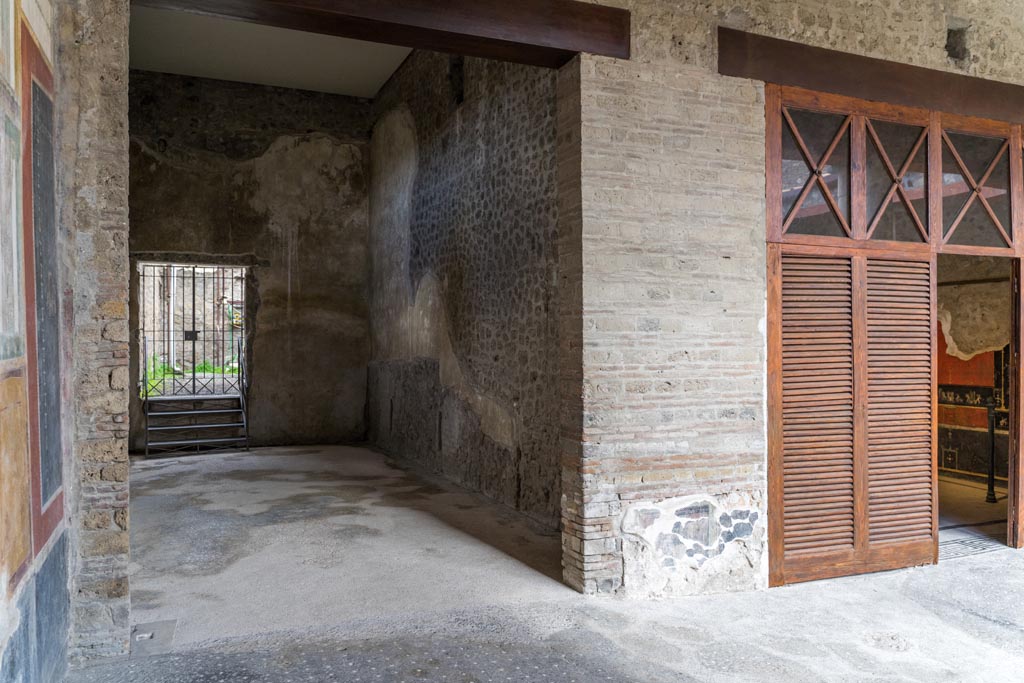 VI.15.1 Pompeii. March 2023. 
Looking towards north-west corner of peristyle on north portico, with the doorway to the “Cupids’ room”, (PPM - room q), on right.  
Photo courtesy of Johannes Eber.

