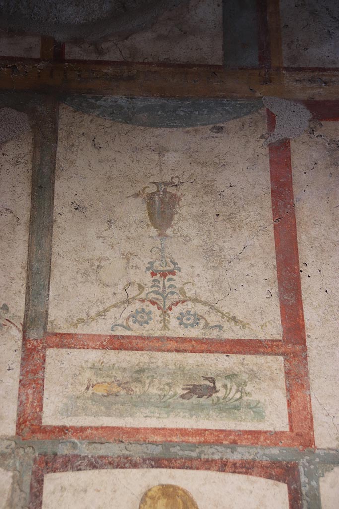 VI.15.1 Pompeii. October 2024. 
Room (f), detail from west wall above candelabrum. Photo courtesy of Klaus Heese.
