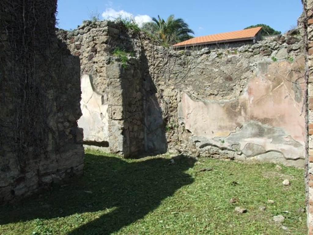 VI.15.5 Pompeii. March 2009. Room 6, ala on north side of atrium. Looking north-west with doorway into room 24.
According to NdS, both alae had a floor of opus signinum. This ala had walls decorated with red and yellow panels.


