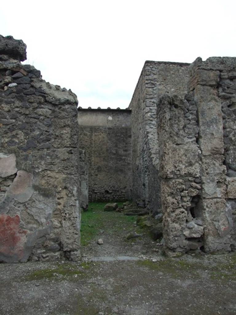 VI.16.5 Pompeii. December 2007. Entrance doorway, looking west. The lava threshold can now be seen in the shop entrance doorway.  The small wall between the shop room and rear room has been knocked down.
