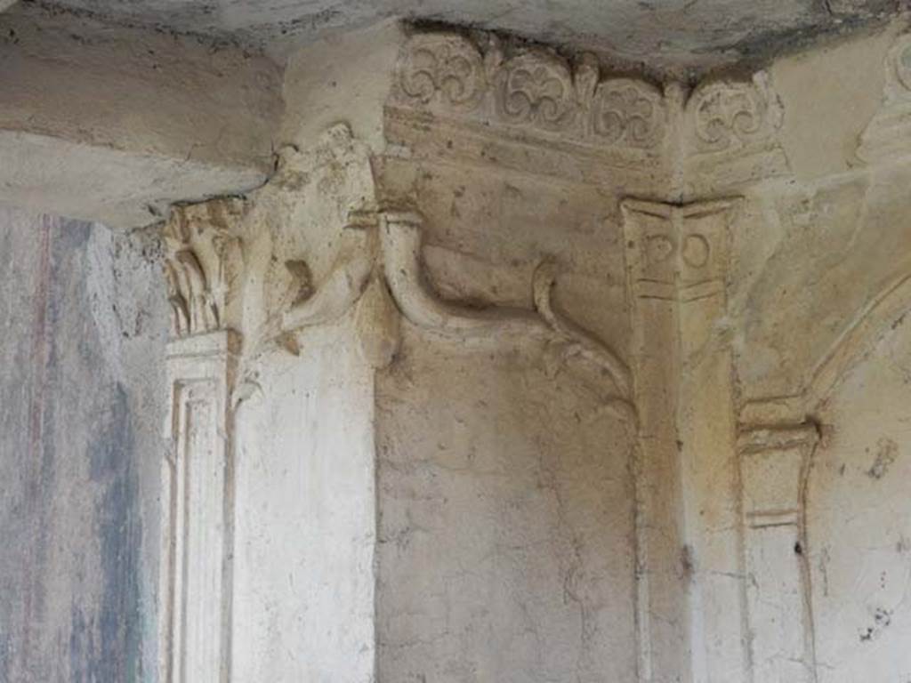 VI.16.7 Pompeii. May 2016. Room F, detail of stucco on lararium. Photo courtesy of Buzz Ferebee.
