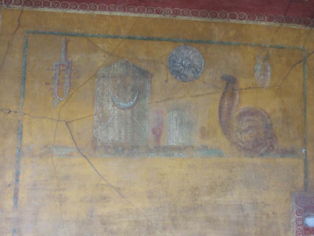 VI.16.7 Pompeii. May 2006. Room F, painting of the attributes of Isis on the east wall of the peristyle.