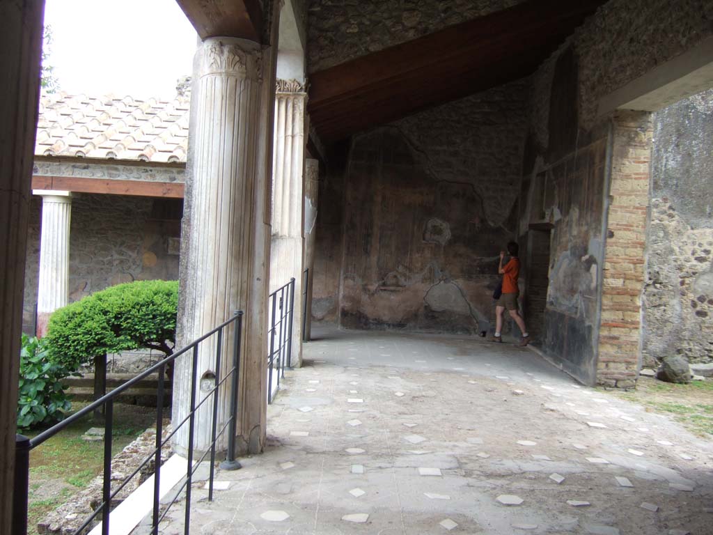 VI.16.7 Pompeii. May 2006. Looking south along room F, west portico.