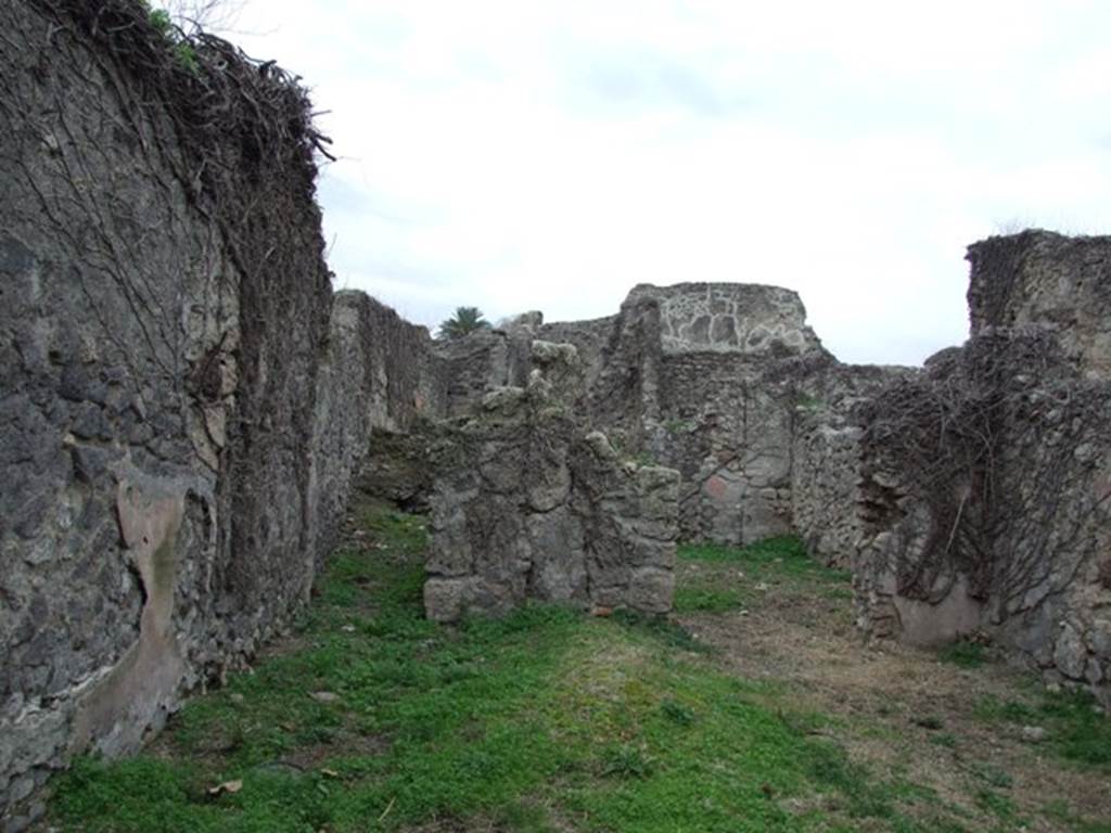 VI.16.11 Pompeii.  December 2007.  Looking west to room in north-west corner of shop and corridor to rear in south-west corner.