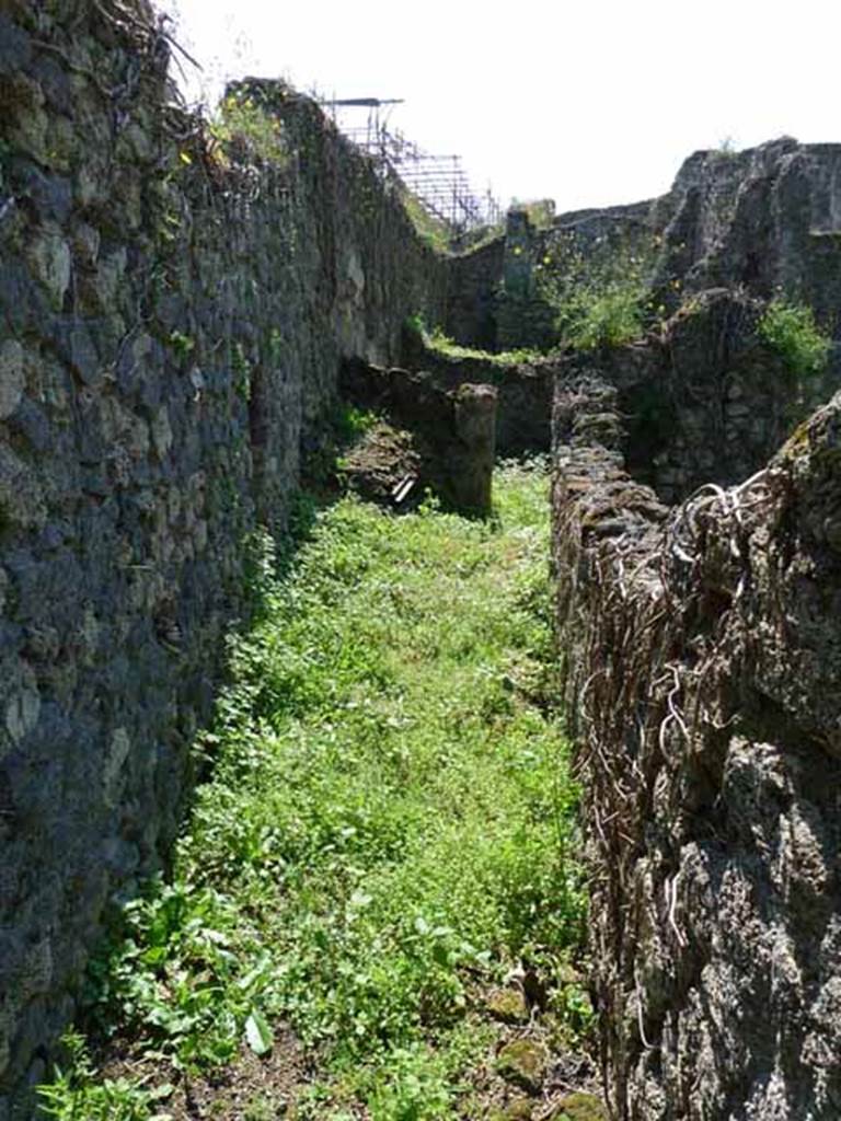 VI.16.11 Pompeii. May 2010. Corridor, looking west to site of latrine and kitchen hearth.
According to NdS, to the south of the rear room was the corridor, and at the back of the corridor was a hearth. 
