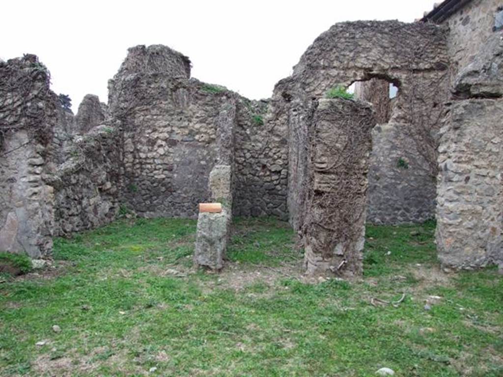 VI.16.13 Pompeii. December 2007. Doorways to three rooms on west side. According to NdS, the room on the left was a small room with opus signinum floor. It was lit by a circular window in the top of the west wall. At the foot of this same west wall, on the floor and also on the sidewalls, one could see the trace left by a very long rectangular form of wooden furniture, that occupied all the lower space from one wall to the other. The room in the centre was a type of small corridor, that received its light from a slit at the top of the west wall. The room on the right had a floor of cocciopesto  and walls faced with rough plaster.
In its western wall was a rectangular window and above it the holes for the beams that supported the upper room. Part of the upper rooms west wall still existed, a continuation of that of the room below, with the remains of the painted decoration, consisting of a panel with a white background, showing the representation of a sea-monster preserved by its serpentine tail, and some small dolphins. See Notizie degli Scavi di Antichit, 1908, (p.63) 