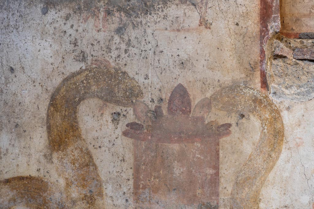 VI.16.15 Pompeii, January 2024. Detail from Lararium in atrium, heads of two serpents at an altar. Photo courtesy of Johannes Eber.