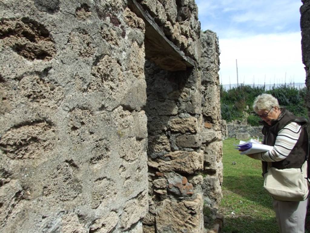 VI.16.27 Pompeii. March 2009. Looking east along corridor leading to peristyle.  North wall, with doorways to rooms U and stairs (V) to upper floor.

