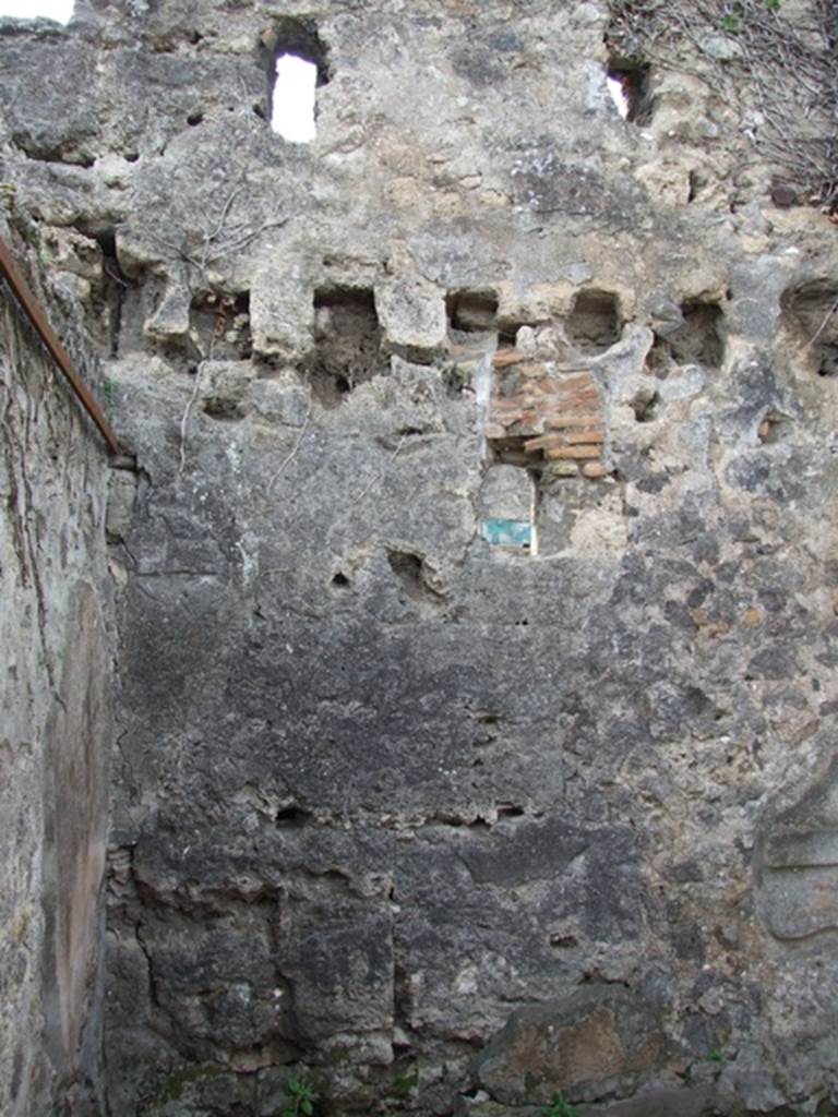 VI.16.27 Pompeii. March 2009. Room U, south-west corner and west wall with window, and sockets for beams to support the upper floor.

