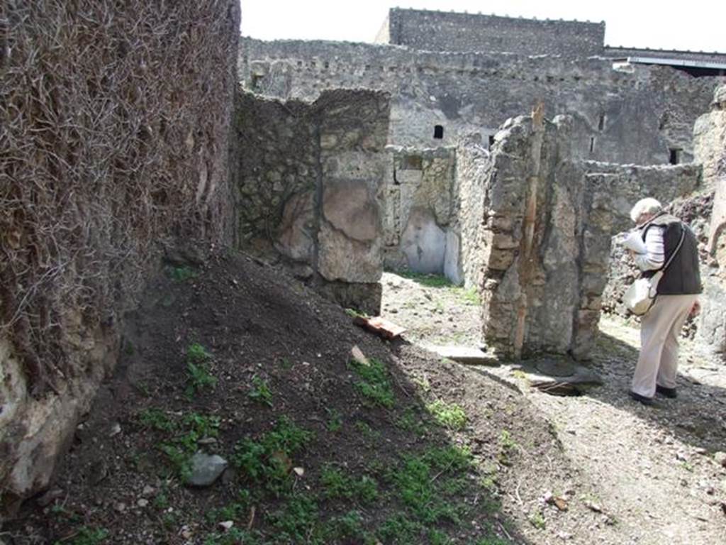 VI.16.28 Pompeii. March 2009.  Looking west across room C, atrium, towards doorway to room D, cubiculum. According to NdS, the doorway to the room had a threshold of lava and with signs of wood towards the atrium. The room was rather large and its upper walls were coated with simple white rough plaster, and below by a high black dado. The dado was divided into large panels by means of slender red bands. See Notizie degli Scavi, 1908, (p.271


