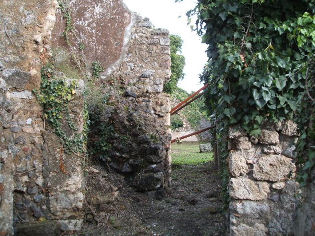 VI.16.31 Pompeii. December 2004. Looking east from entrance doorway. The doorway led immediately into a short and wide fauces A, with earth floor and rustic walls. In the centre left of this photo can be seen the remains of the ramps of masonry stairs that led above. On the left of this photo was a doorway into a large room B, which was as rustic as the corridor.
In the top of the west wall was a window, and there was a niche in the south wall. In the south-west corner was a low masonry structure. According to Eschebach room B was the kitchen.
See Eschebach, L., 1993. Gebudeverzeichnis und Stadtplan der antiken Stadt Pompeji. Kln: Bhlau. (p.231)
According to Boyce, in the kitchen (?) on the left side of the fauces, in the south wall above the hearth (?) was a rectangular niche (h.0.30, w.0.22, d.0.22, height above the floor 1.50). See Boyce G. K., 1937. Corpus of the Lararia of Pompeii. Rome: MAAR 14. (p.59, no.228)
According to Giacobello, in the kitchen (room E) was a niche on the south wall, near the hearth. Today there is no trace. See Giacobello, F., 2008. Larari Pompeiani: Iconografia e culto dei Lari in ambito domestico.  Milano: LED Edizioni. (p.186)
