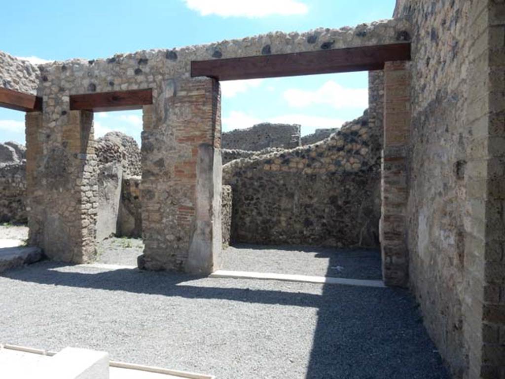 VII.1.25 Pompeii. May 2017. 
Looking south-east across atrium 24 to rooms 29, cubiculum, and room 30, an ala. Photo courtesy of Buzz Ferebee.
According to Niccolini –
The other two small rooms which give onto the atrium marked by numbers 7 and 9 (our rooms 30 and 28) were decorated with several paintings.
The very spacious entrance to the one in the wall located to the right, (think he is talking about our room 30) has no vestiges of closure on its marble threshold. The zoccolo/plinth, however, was adorned with green painted plants and birds. On the walls, are painted panels in yellow, red, and white, and candelabra, and festoons, and domestic birds, and the human-headed Sphinx, and whimsical architectures and landscapes.
All this makes this little room rather charming, which certainly would have been an ala of the atrium, while the room that was facing and corresponding to the ala across the atrium on its wall to the right, was a cubiculum 9 (our room 28). 
(“Le altre due piccole stanze che dan sull’ atrio segnate co’ numeri 7 e 9 ornate sono da svariati dipinti. (nostri ambienti 30 e 28).
L’ingresso assai spazioso di quella nel muro a destra situata, non ha vestigia di chiusura sulla sua soglia di marmo.
Lo zoccolo pero era ornato da verdi piante e da augelli. Sulle pareti scompartite di giallo, di rosso, e di bianco son dipinti e candelabri, e festoni, e domestici uccelli, e l’androsfinge, e capricciose architetture e paesaggi.
Tutto ciò fa vaga assai questa stanzetta che certo un’ala dell’atrio esser doveva, mentre l’ala che le sta rimpetto e che pur nell’atrio corrisponde, sul suo muro a destra, era un cubicolo 9 (ambiente 28 sulla nostra pianta)”.
See Niccolini F, 1854. Le case ed i monumenti di Pompei: Volume Primo. Napoli, Strada Stabiana, Casa numero 57, Strada Stabiana, Casa numero 57, p.2.

