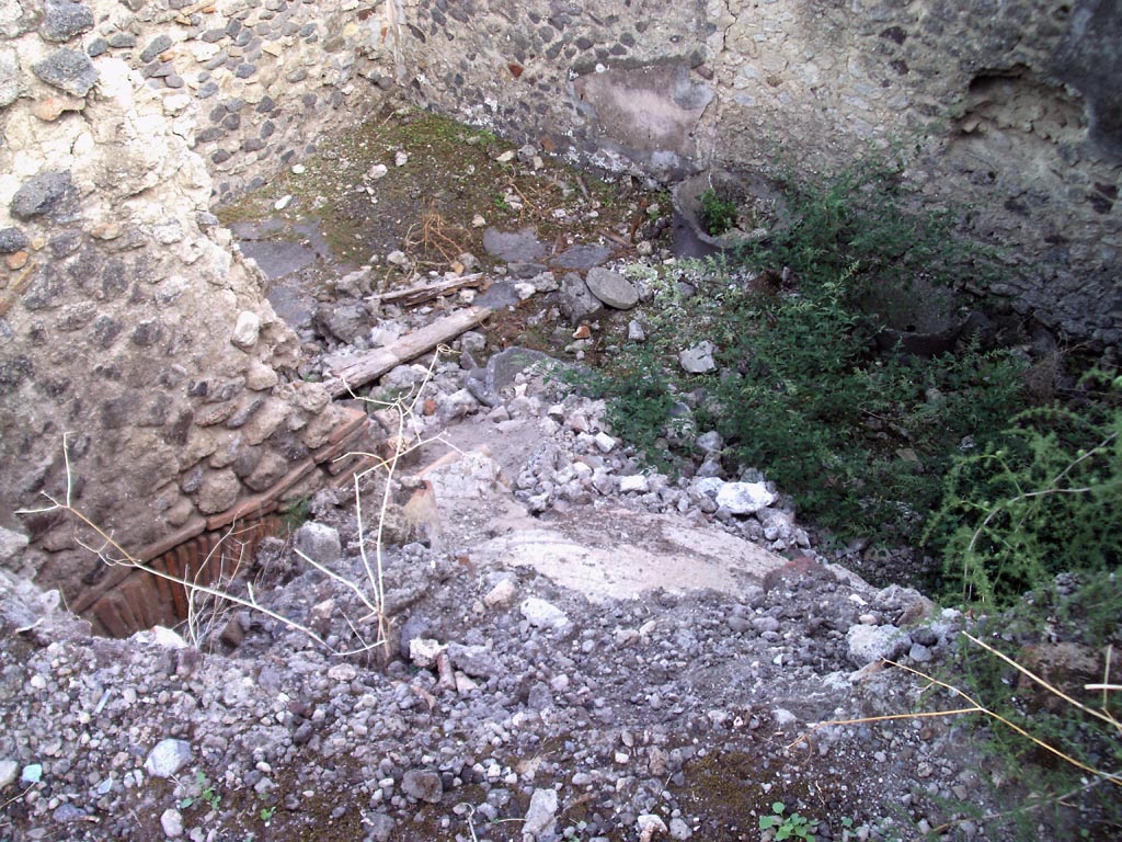 VII.1.36 Pompeii. August 2008. 
Looking south-east across top of rear of oven towards room in south-west corner with mills. Photo courtesy of Jared Benton.
