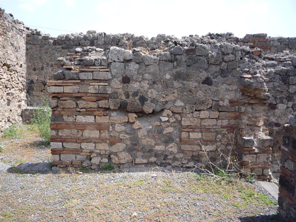 VII.1.36 Pompeii. October 2009. 
Looking east in south-east corner of atrium. The doorway to the milling room is on the right. Photo courtesy of Jared Benton.
