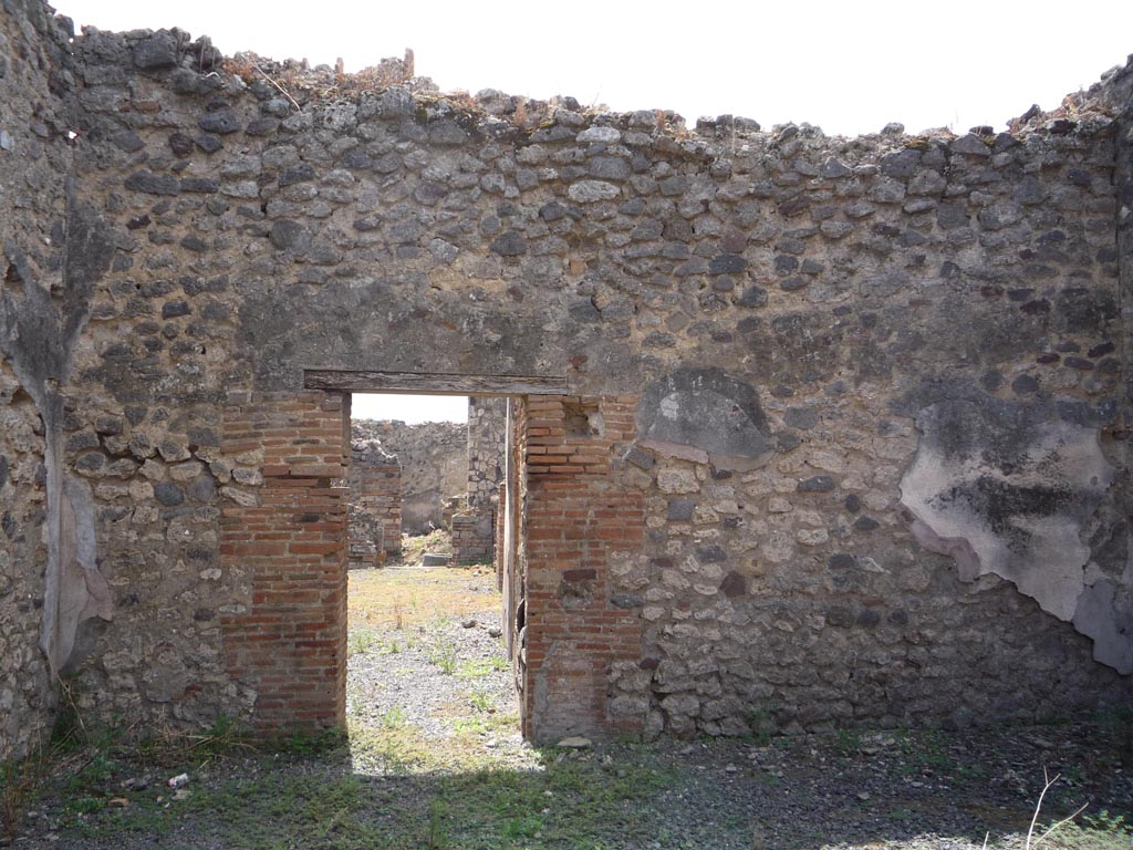 VII.1.36 Pompeii. October 2009. Looking towards south wall, with doorway to bakery at VII.1.36. Photo courtesy of Jared Benton.