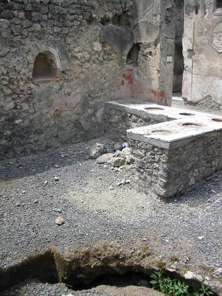 VII.1.39 Pompeii. May 2003. 
Looking north-west across counter, with niche in west wall. Photo courtesy of Nicolas Monteix.

