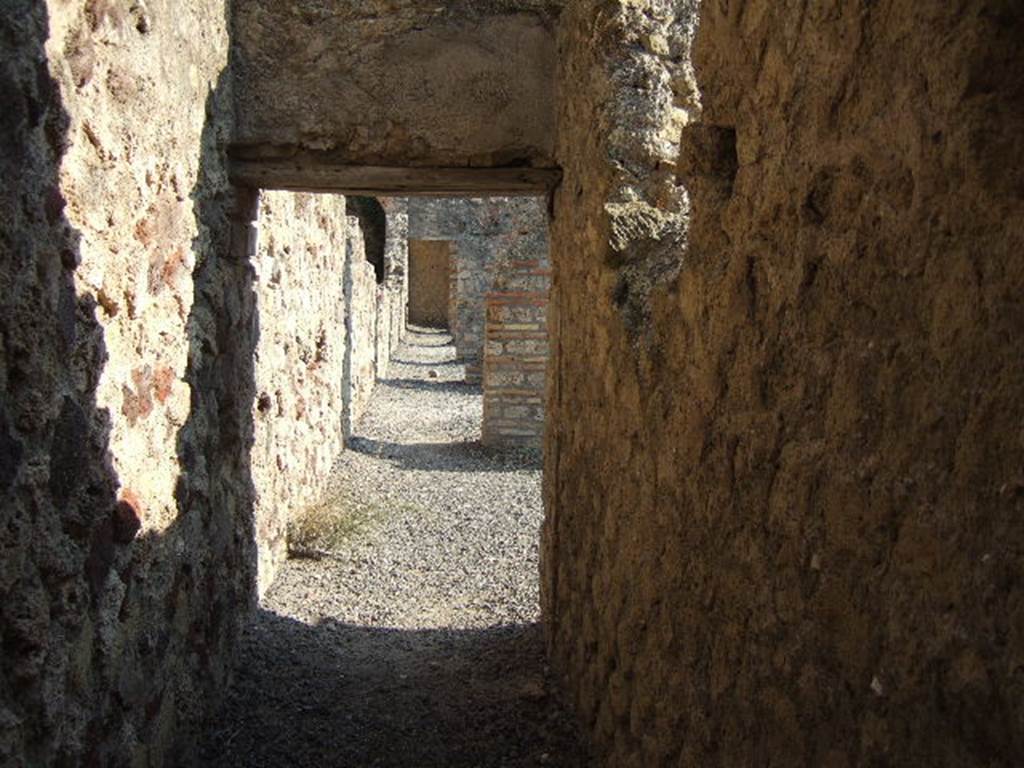 Corridor at rear of shops VII.1.52-VII.1.57 taken from Stabian Baths. Looking south.