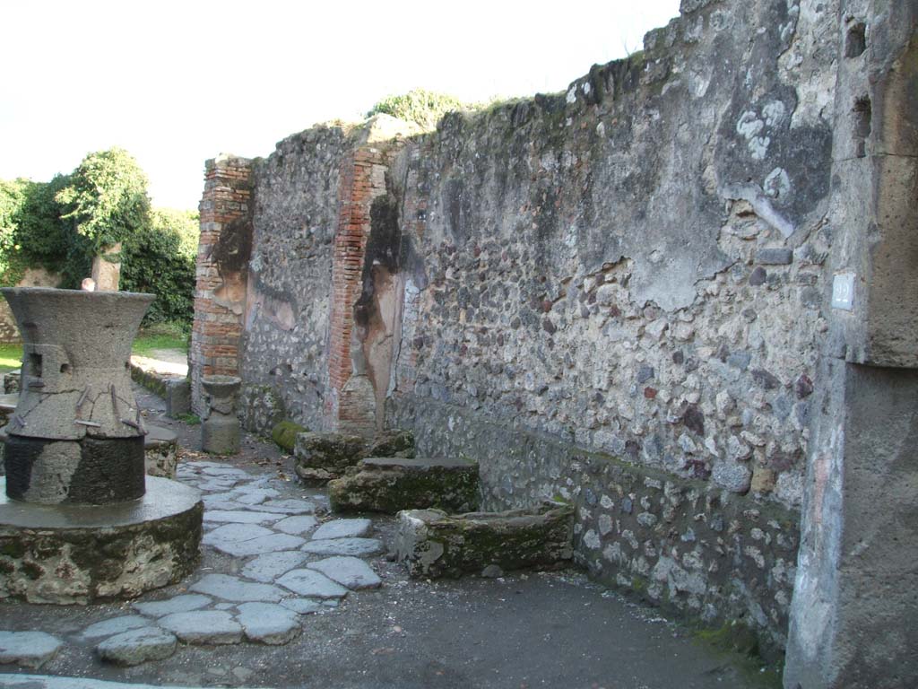 VII.2.22 Pompeii. December 2004. South wall of bakery with supports for bench or table.