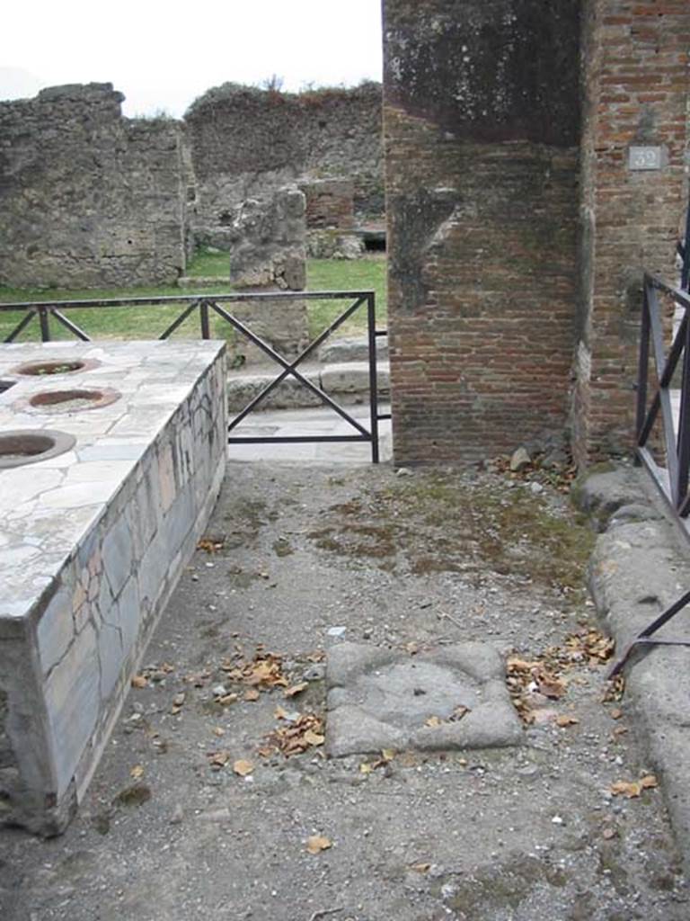 VII.2.32 Pompeii. May 2003. Looking south on west side of bar-room, near entrance at VII.2.32, looking towards VII.2.33 on Via degli Augustali. Photo courtesy of Nicolas Monteix.
