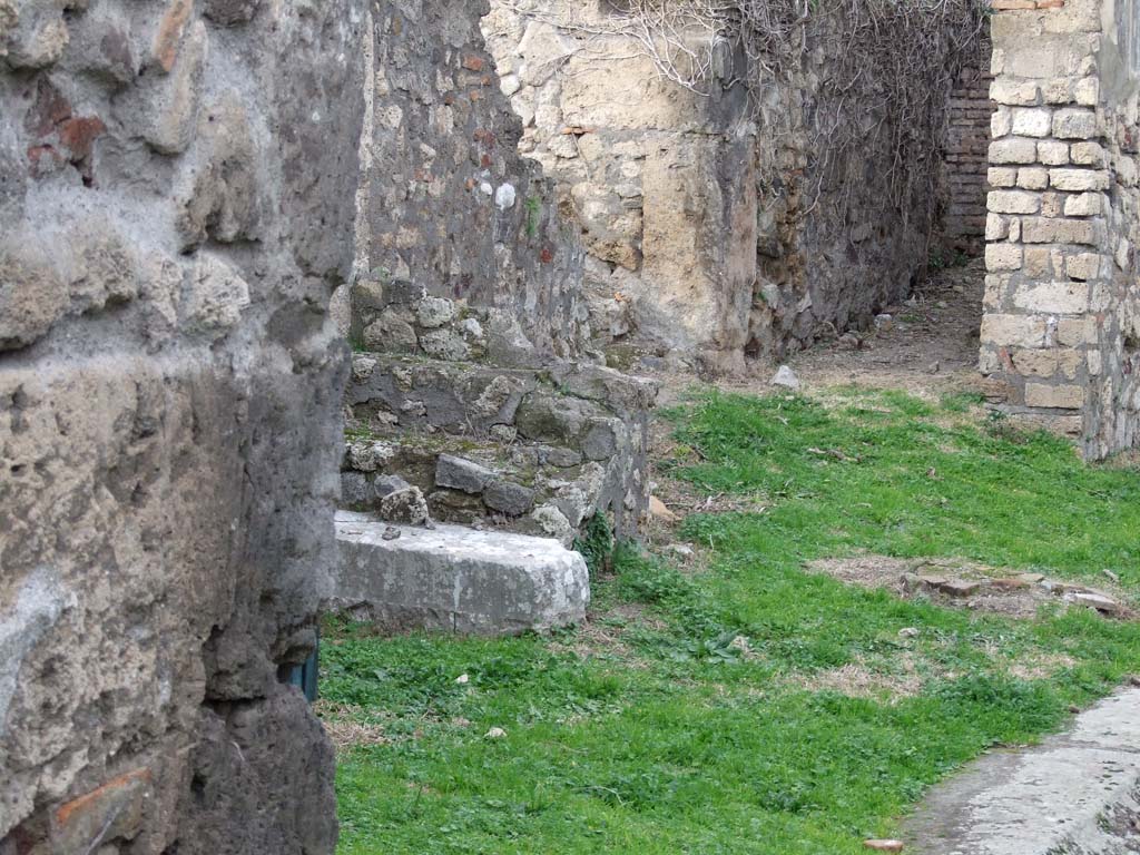 VII.2.35 Pompeii. December 2007. West side of atrium with the remains of staircase. At the rear is the corridor linking to VII.2.27.